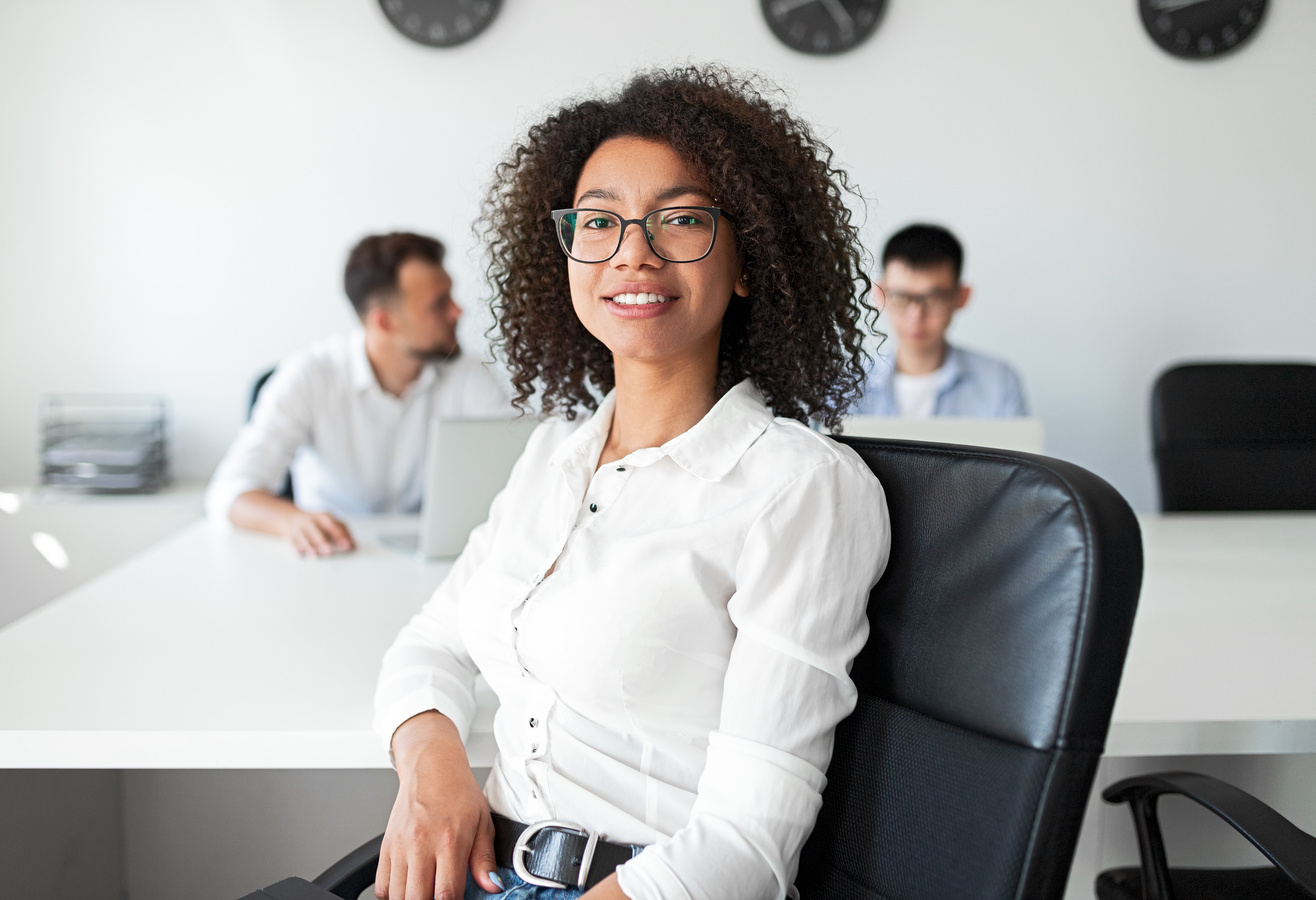 Ethnic employee sitting in office